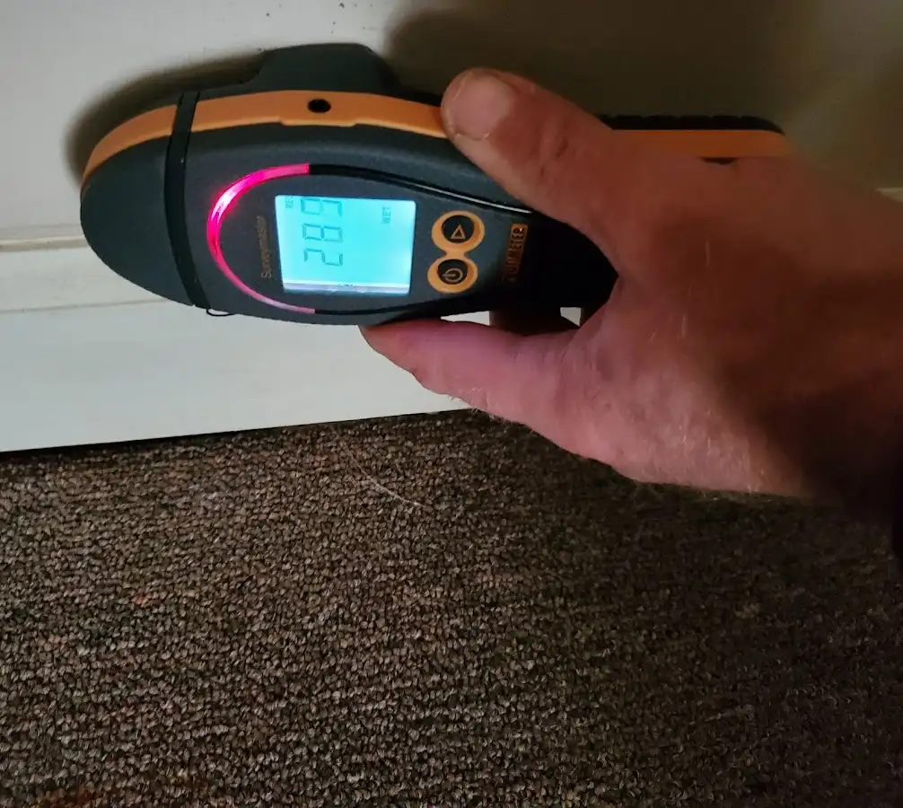 Moisture detection at baseboard during Storm Damage Restoration in Winter Beach